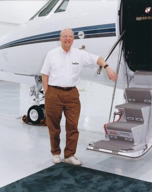 A man standing on the steps of an airplane.