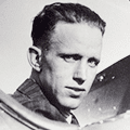 A man in military uniform is looking at the camera.