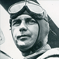 A man wearing an old-fashioned flying helmet.