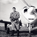 A man standing in front of an airplane.