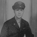 A man in uniform wearing a hat and jacket.