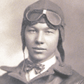 A man wearing an aviator 's hat and goggles.