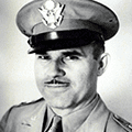 A black and white photo of an officer in uniform.