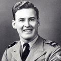 A man in uniform is smiling for the camera.