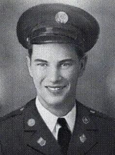 A man in uniform is smiling for the camera.