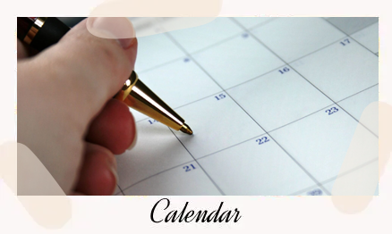A person is writing on the calendar